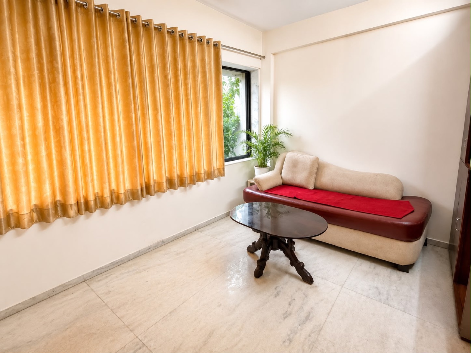 Sitting room with diwan and golden curtains